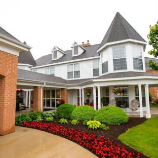 A beautiful residential home with manicured gardens and unique architectural features.