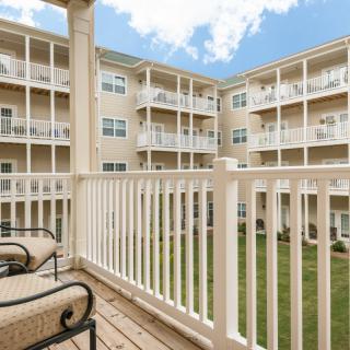 A view from the balcony of an apartment overlooking a courtyard.