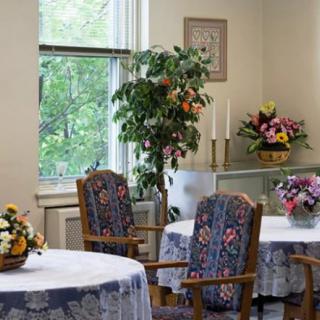 A cozy dining room with floral decorations and natural light.
