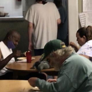 A group of people sharing a meal together in a community setting.