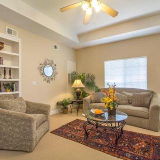 A cozy living room with comfortable seating and elegant decor.