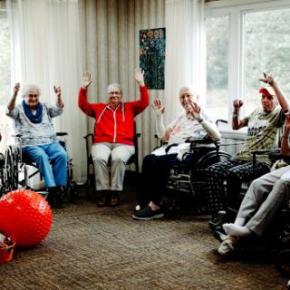 Residents participate in a fun group activity at a care facility, showcasing joy and engagement.