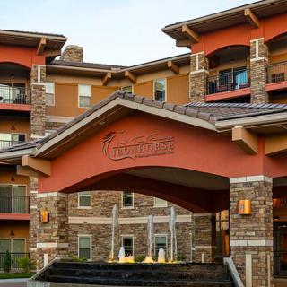 A residential building entrance with a fountain and stone accents.