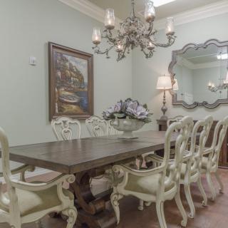 Elegant dining room with a chandelier and classic decor.