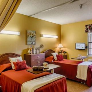A cozy shared bedroom with twin beds and warm lighting.