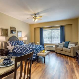 A cozy bedroom with elegant furnishings and natural lighting.