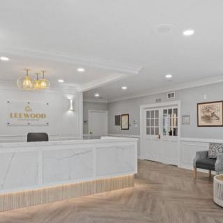 A modern reception area with a front desk and seating, designed with elegant decor.