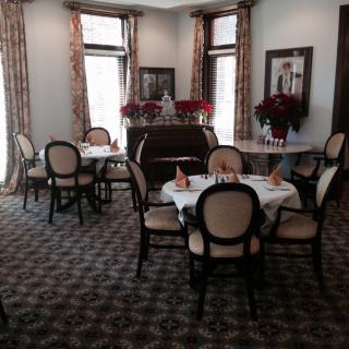 A beautifully set dining area with elegant tables and chairs, located in a well-decorated restaurant interior.