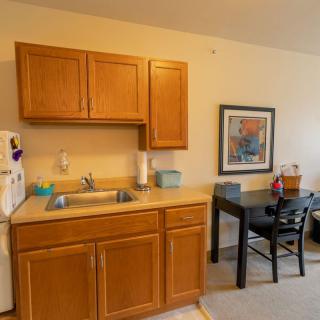 A cozy kitchen area with wooden cabinets and a small dining table.