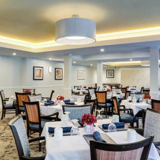 An elegant restaurant dining area with neatly arranged tables and chairs, ready for guests.