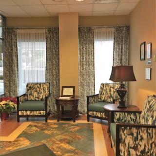 A cozy waiting area featuring comfortable chairs and warm lighting.