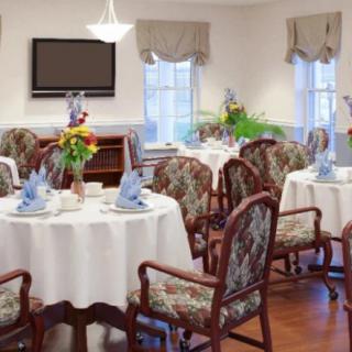 An elegant dining room with beautifully set tables and floral arrangements.