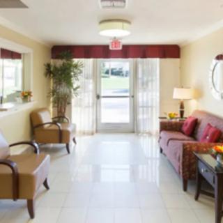 A cozy waiting room with comfortable seating and soft lighting.