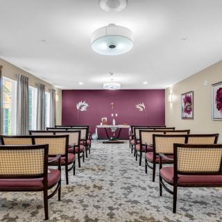 A neatly arranged conference room with chairs facing a table, set up for a meeting or presentation.