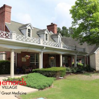 A picturesque view of a village-style building designed for healthcare and community living.