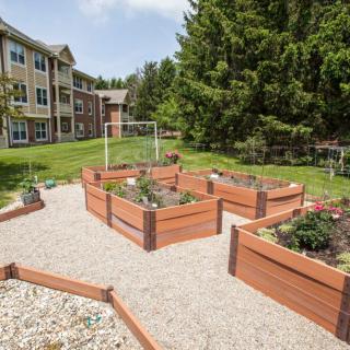 A community garden with raised beds located in a residential area.