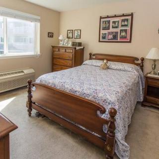 A cozy bedroom with wooden furniture and a large bed.