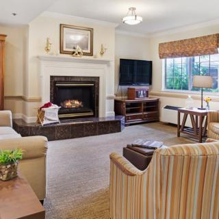 A cozy living room with a fireplace and comfortable seating arrangement.