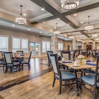 An elegant dining area with well-arranged seating and stylish chandeliers.