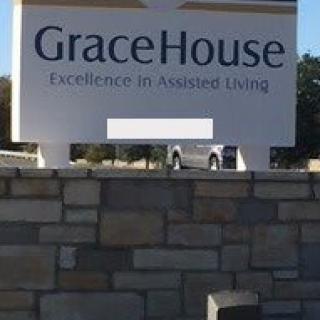 Sign for GraceHouse Assisted Living on a stone wall.