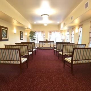 A well-lit room with arranged seating and decor.