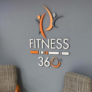 The Fitness 360 logo displayed prominently in a modern gym setting.