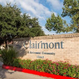 Entrance to The Clairmont Retirement Community with brick signage and surrounding greenery.