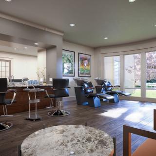A spacious modern living room interior with stylish furniture and large windows.
