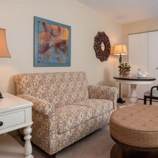 A cozy living room with a patterned sofa and stylish decor.