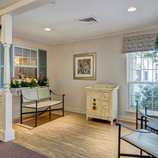 A cozy living room with seating and decorative elements.