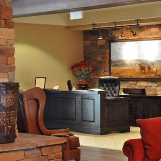 A cozy hotel lobby featuring a reception desk and comfortable seating area.