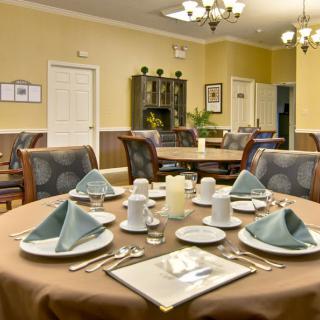 An elegantly set dining table in a well-decorated room.