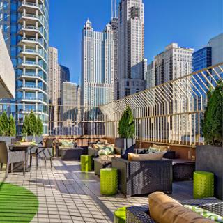 A stunning rooftop lounge with a modern aesthetic, offering breathtaking views of the city skyline.