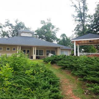A serene house surrounded by greenery.