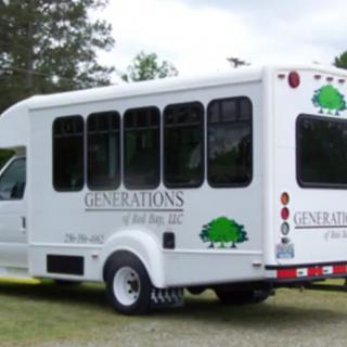 A white shuttle bus parked outdoors.