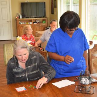 A caregiver assists seniors in a nursing home setting.