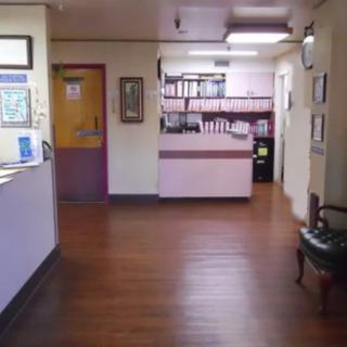An office reception area with a desk and waiting space.