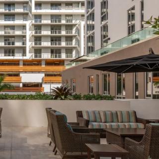Modern outdoor seating area in an urban apartment complex.