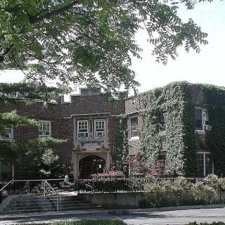A historical brick building covered in lush green ivy.