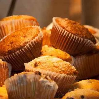 A delicious assortment of freshly baked muffins piled together.