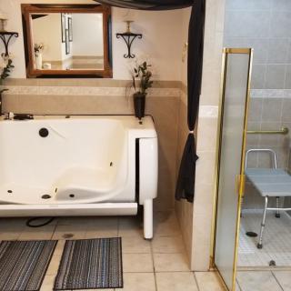 A well-designed bathroom featuring a bathtub and a glass-enclosed shower.
