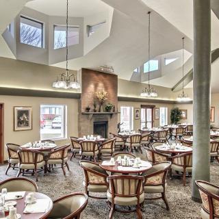 A spacious dining area with elegantly set tables and large windows.
