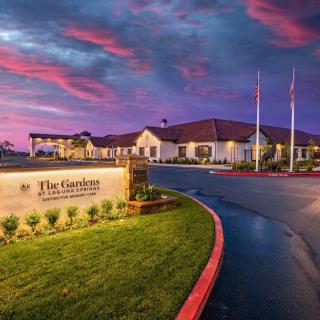 A scenic view of a retirement community building at sunset with vibrant skies.