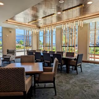 A stylish and modern dining area featuring elegant furniture and ample natural light.