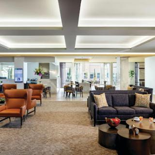 A modern and spacious living room featuring elegant furniture and contemporary lighting.