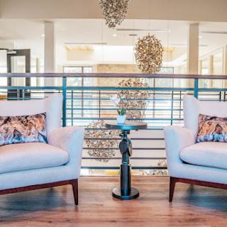 A stylish and modern living room setup featuring elegant chairs and unique lighting.