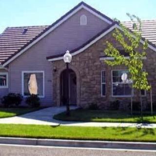 A charming residential house with a landscaped front yard.