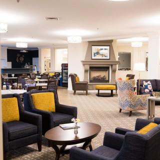 A spacious and modern living room with comfortable seating and a fireplace.