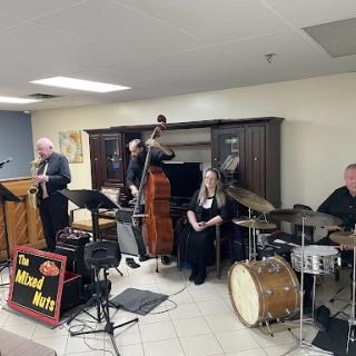 A jazz band performing live, featuring a variety of instruments.