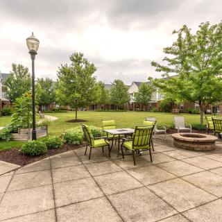 A spacious outdoor patio with seating area overlooking a landscaped garden.